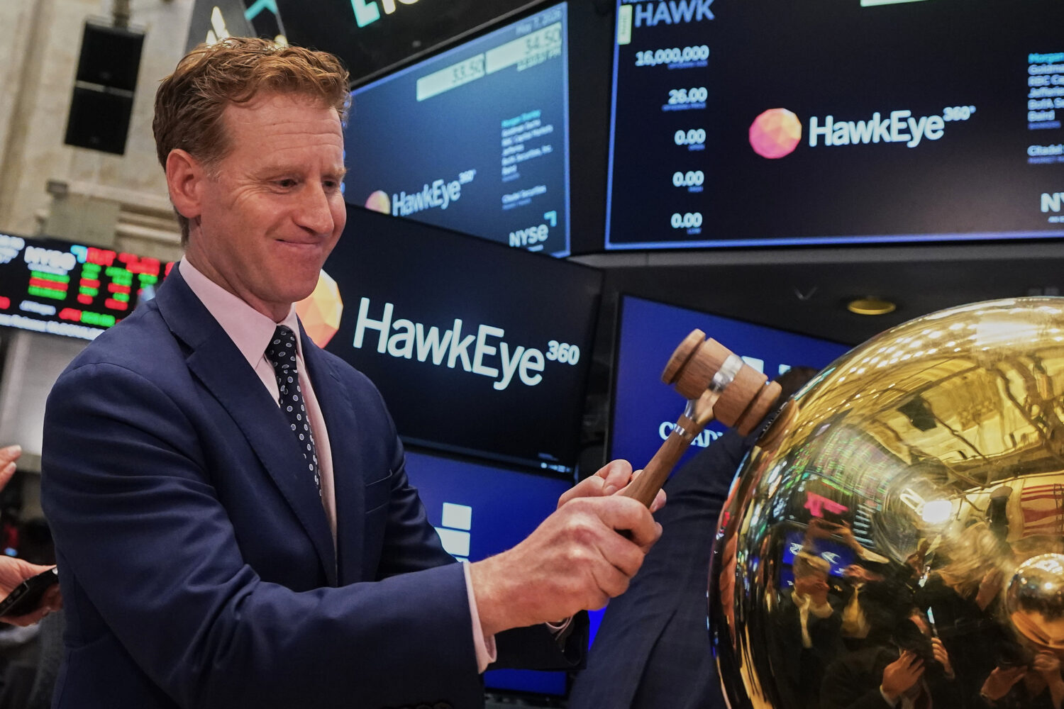 HawkEye 360 CEO John Serafini rings a ceremonial bell on the floor of the New York Stock Exchange a...