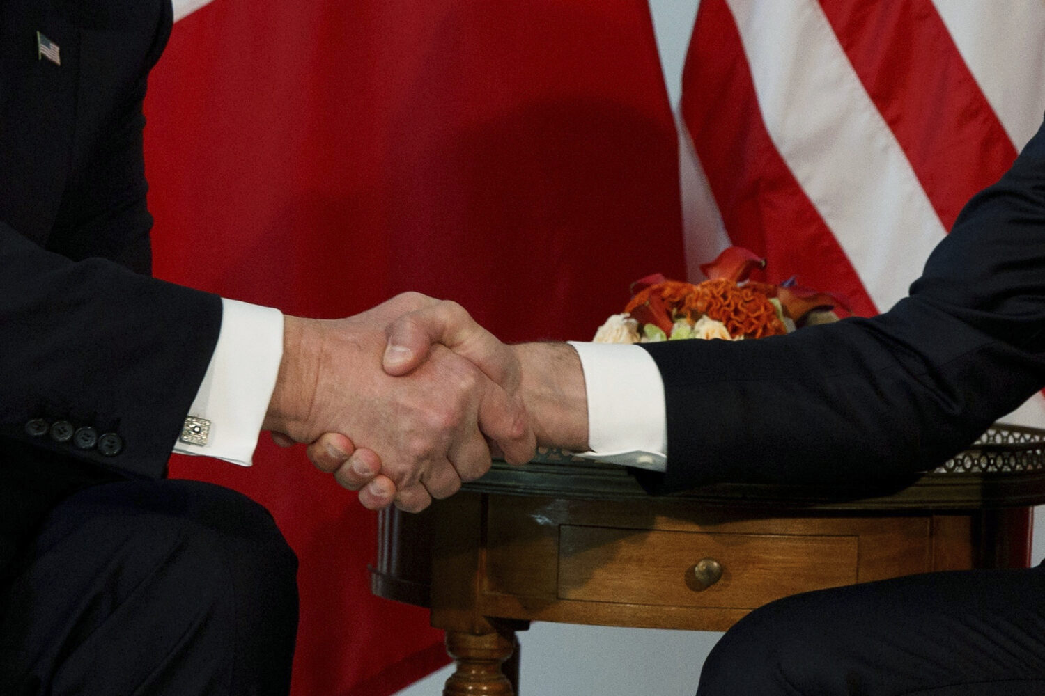 FILE - President Donald Trump shakes hands with French President Emmanuel Macron during a meeting a...