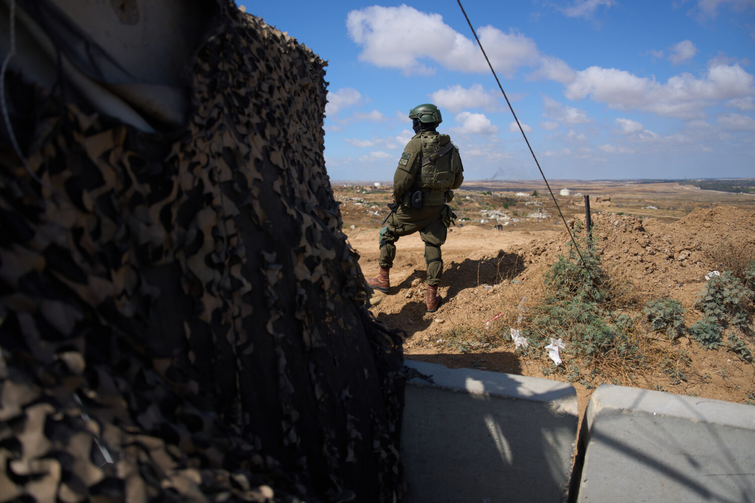 An Israeli soldier occupies a military position overlooking the so-called Yellow Line in the centra...