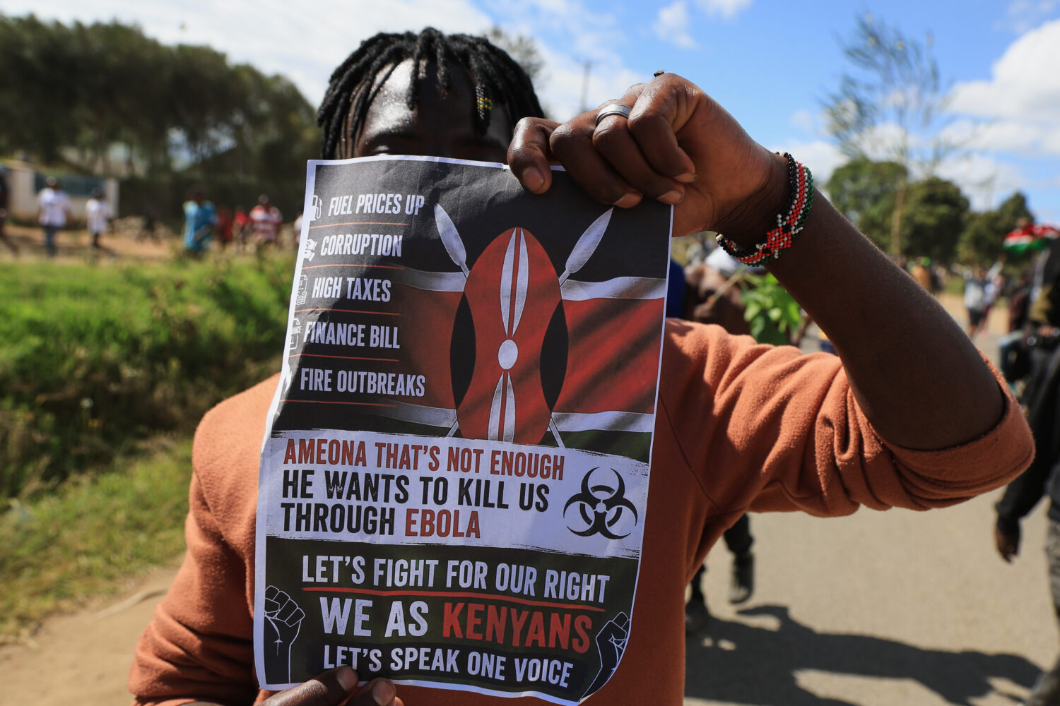 A protester holds up a placard during a demonstration against a proposed Ebola quarantine center to...