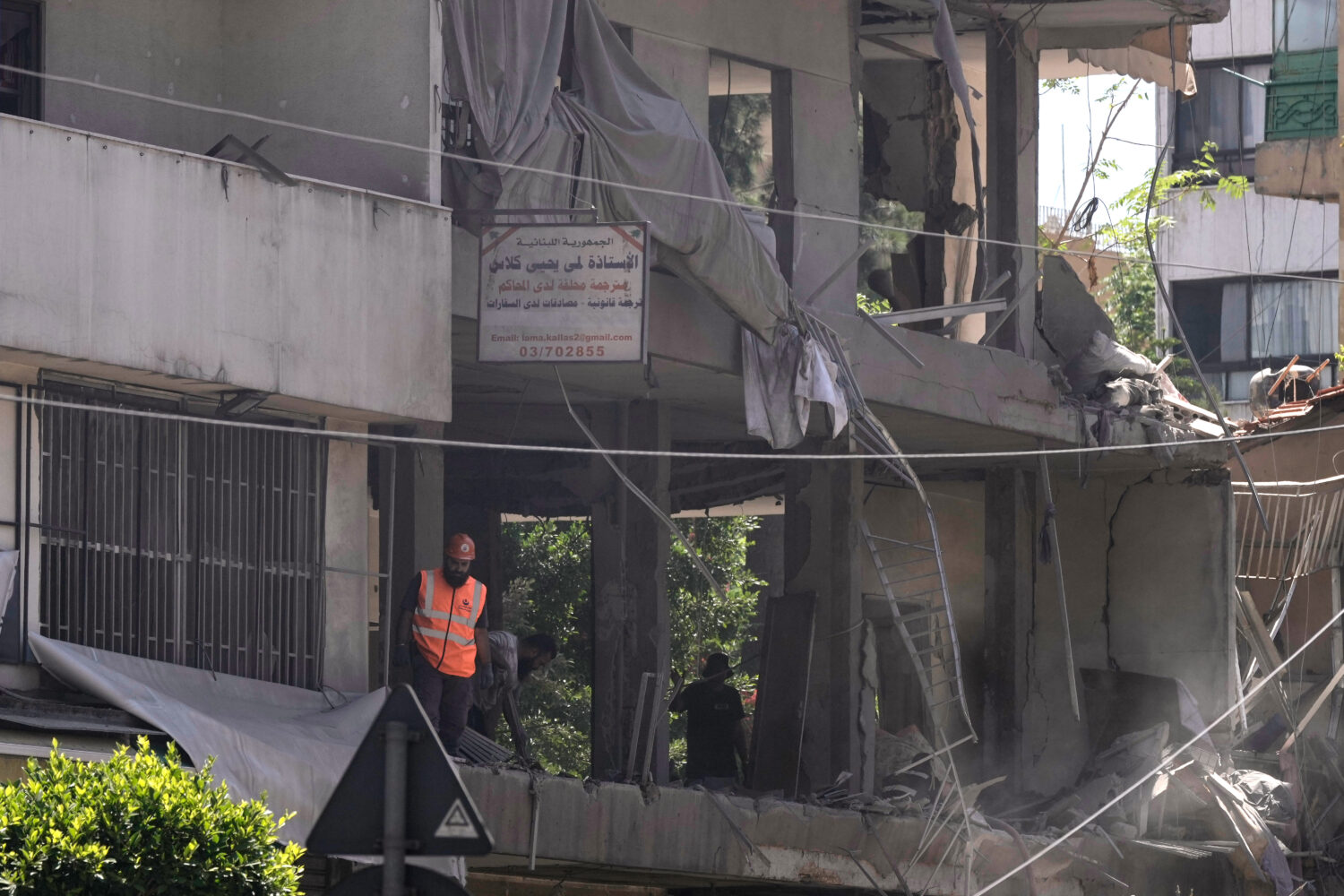 A rescue worker checks an apartment that was hit in an Israeli airstrike in Dahiyeh, Beirut's south...