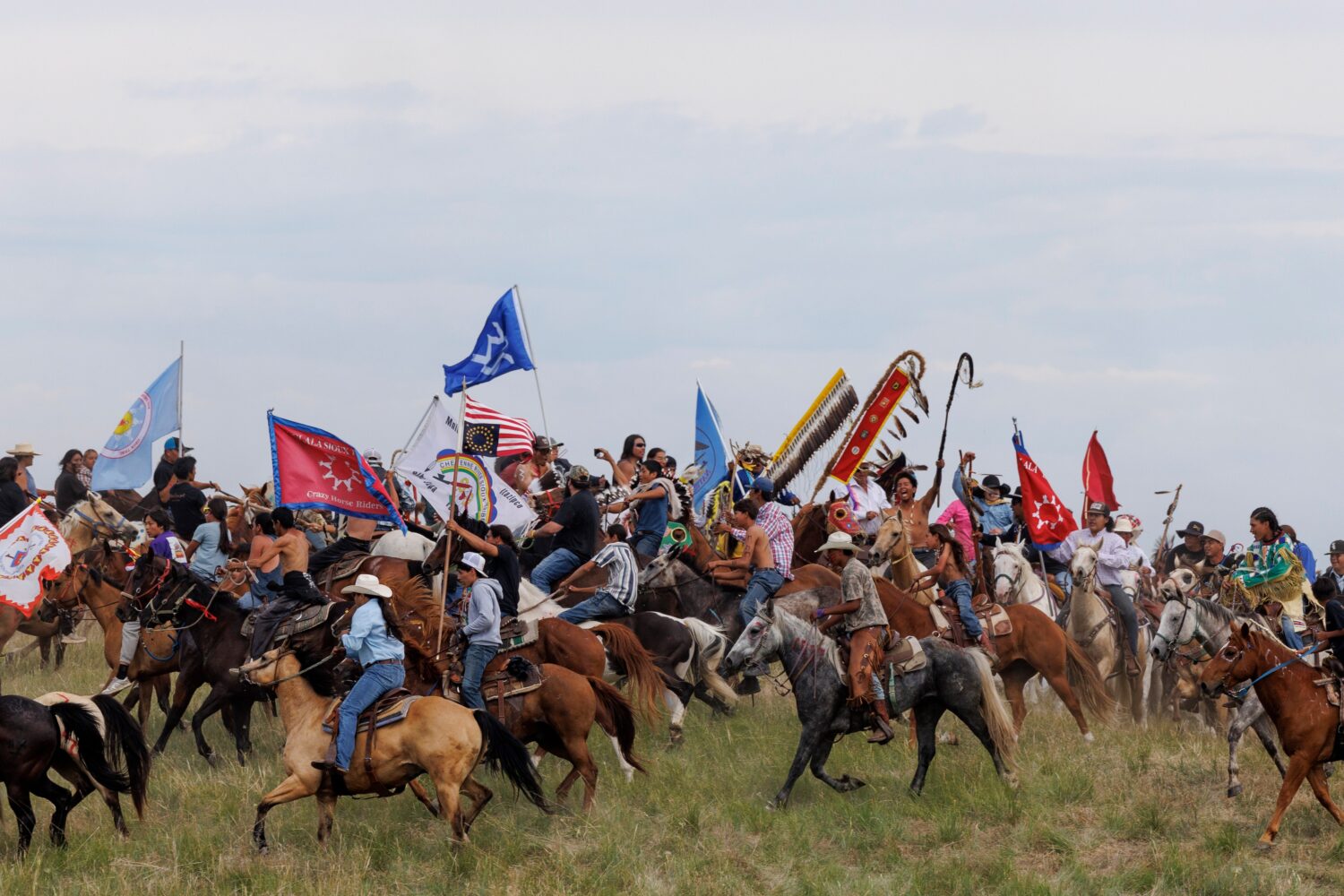 Riders circle the elders representing each tribe present for the horse charging during festivities ...