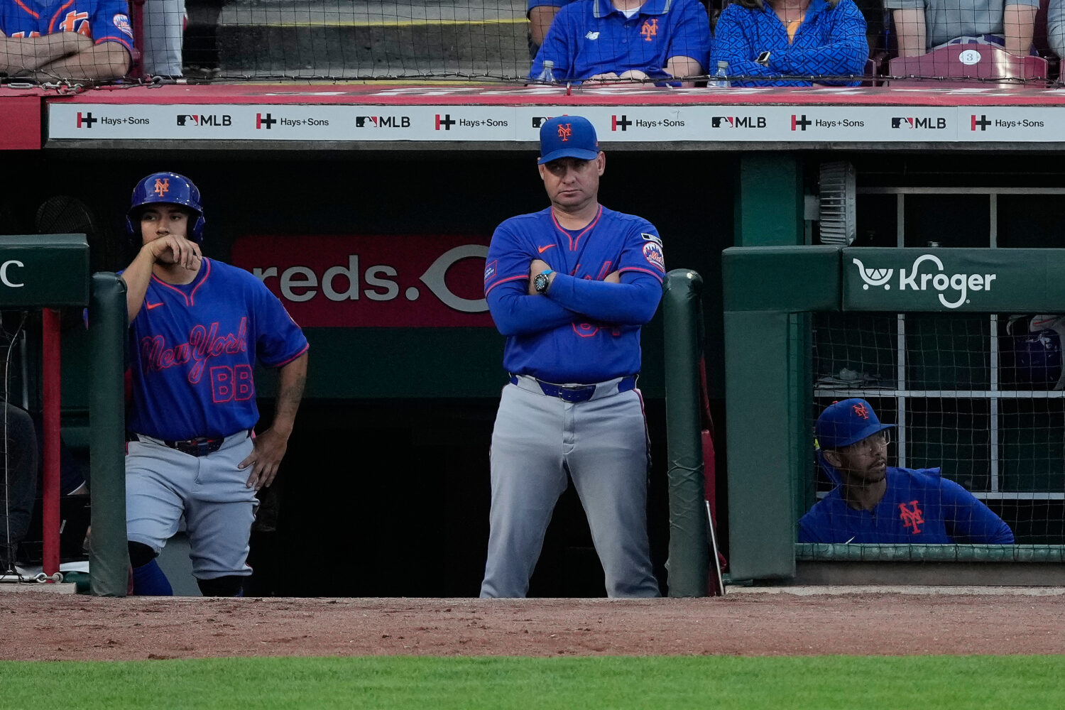 New York Mets manager Carlos Mendoza center, looks out from the dugout during the fourth inning of ...