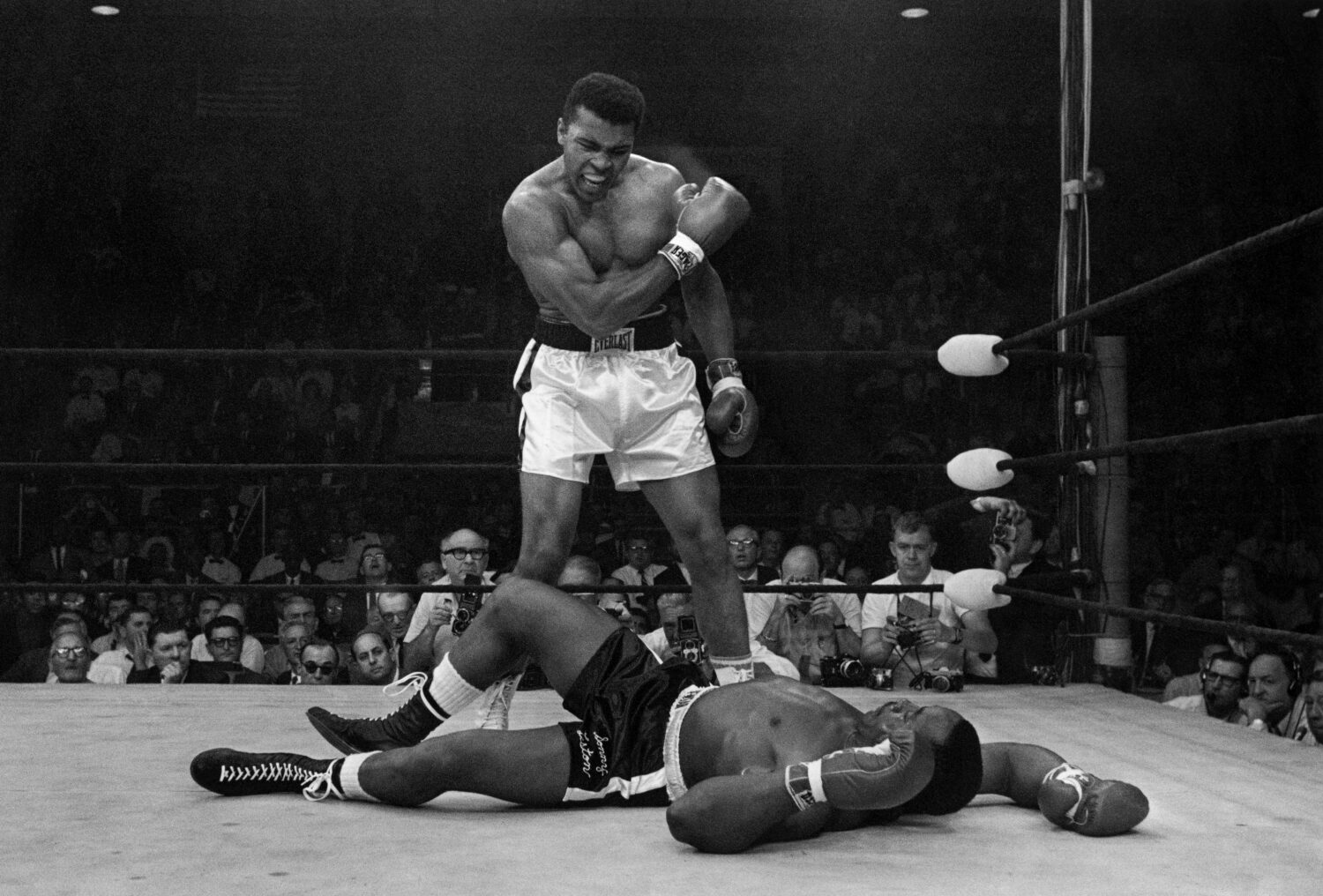 FILE - Heavyweight champion Muhammad Ali stands over fallen challenger Sonny Liston, shouting and g...