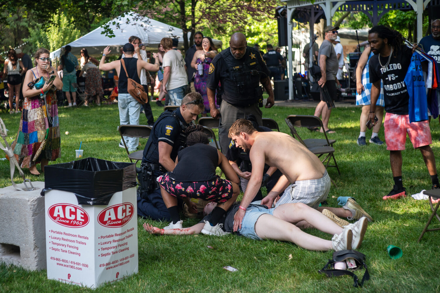 Police treat a person after multiple people were shot at a community festival Saturday, June 6, 202...