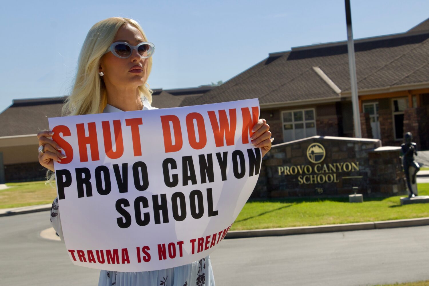 Paris Hilton protests outside the Provo Canyon School, where she says she suffered abuse as a teen,...