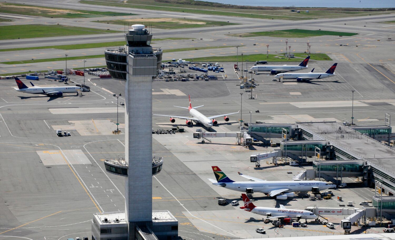 FILE - The air traffic control tower rises above terminals at John F. Kennedy International Airport...