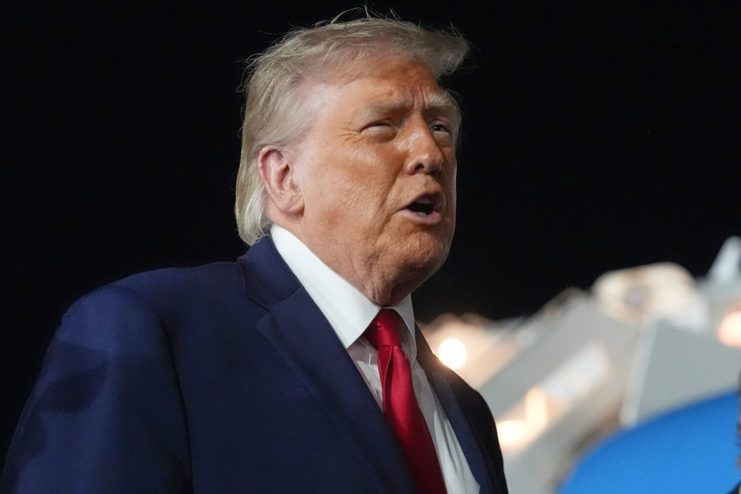 President Donald Trump talks with reporters before boarding Air Force One at John F. Kennedy Intern...