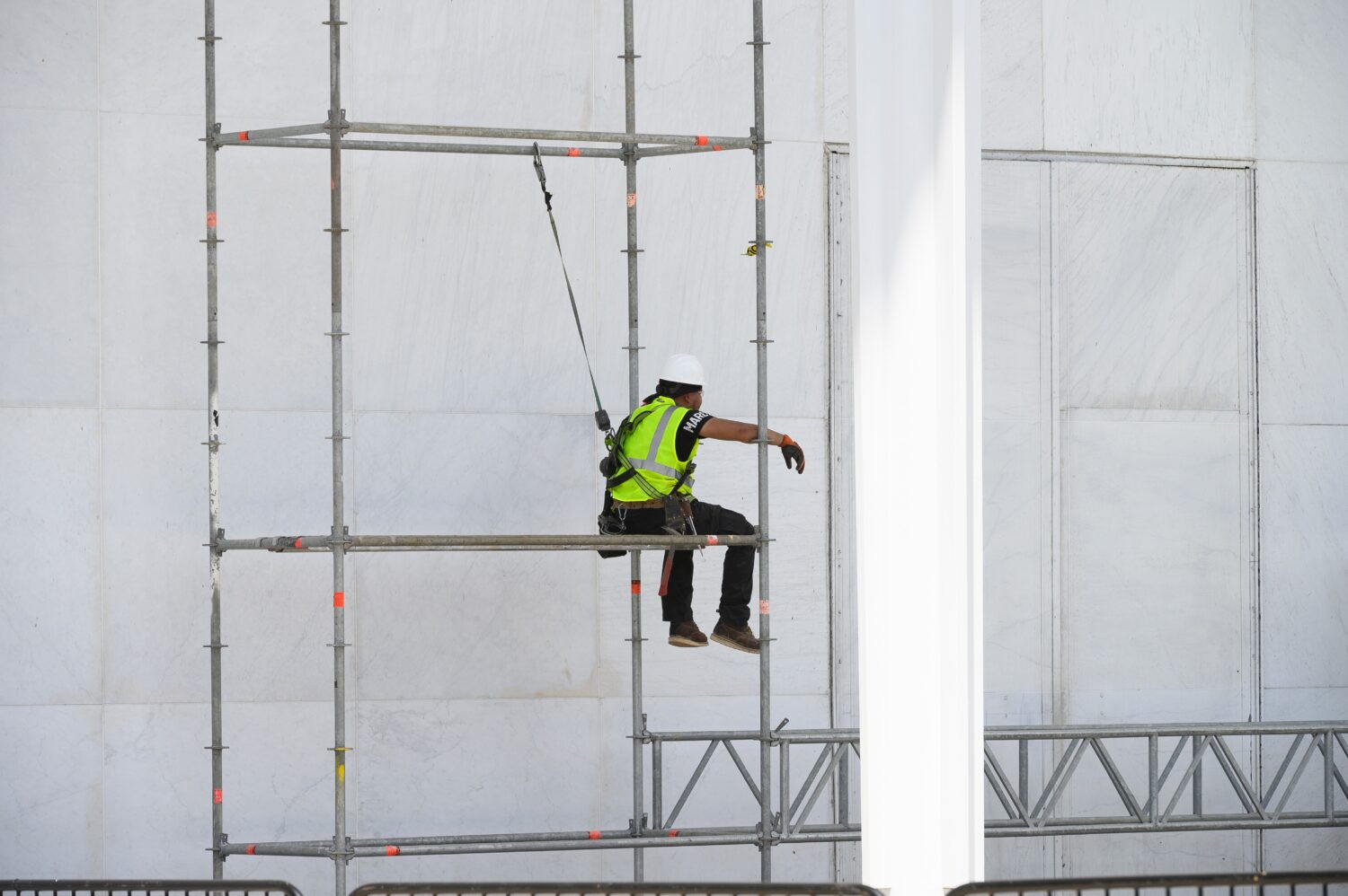 A worker sits on scaffolding at the John F. Kennedy Center for the Performing Arts in Washington, F...