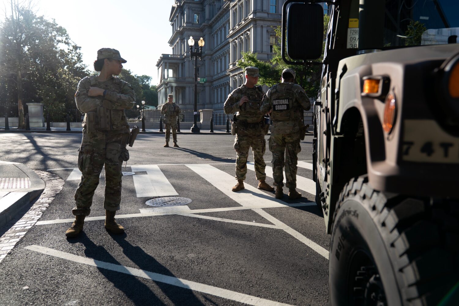 Members of the National Guard stands guard the streets near the White House complex Saturday, June ...
