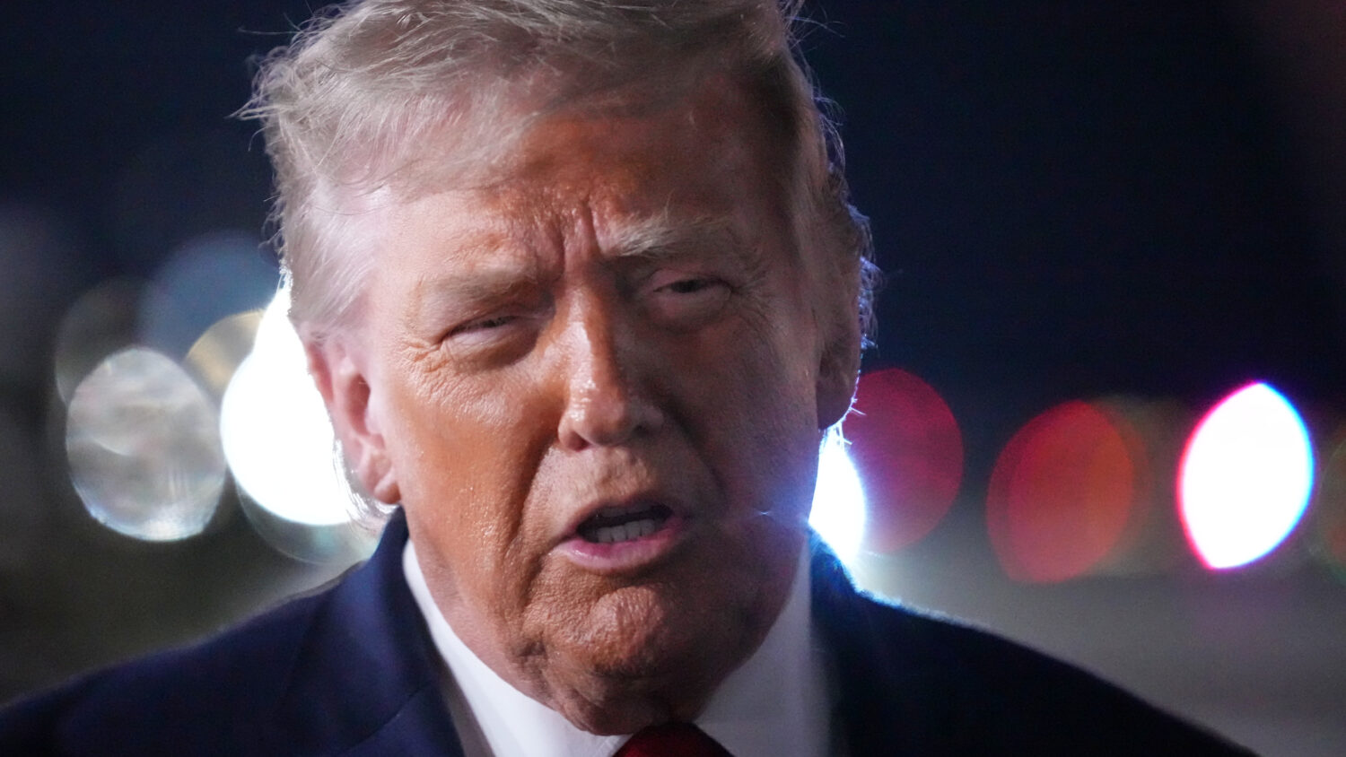President Donald Trump talks with reporters before boarding Air Force One at John F. Kennedy Intern...