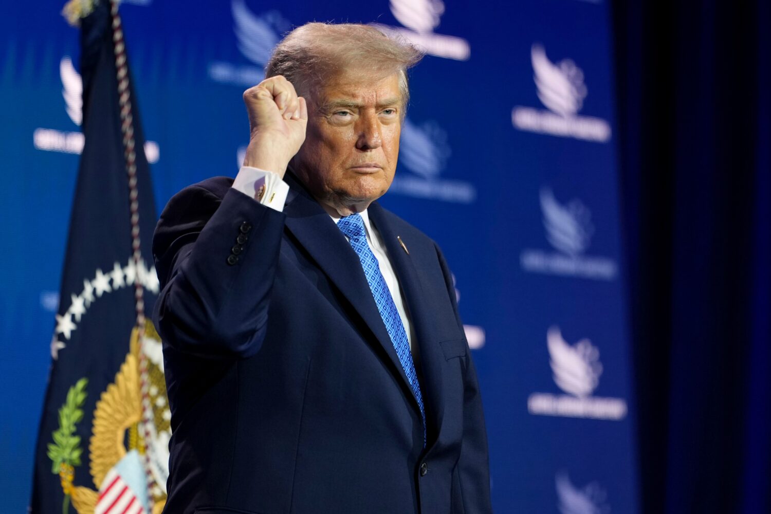 President Donald Trump addresses the crowd as he departs after speaking at the Faith & Freedom Coal...