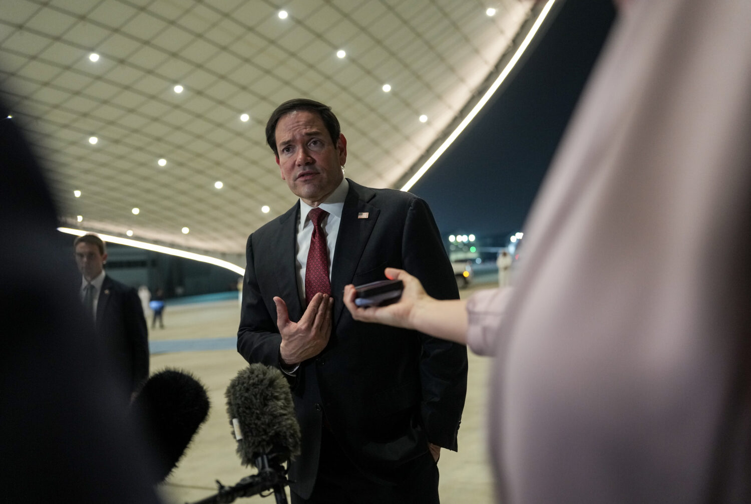 Secretary of State Marco Rubio speaks to the media upon his arrival at Al Bateen Executive Airport,...