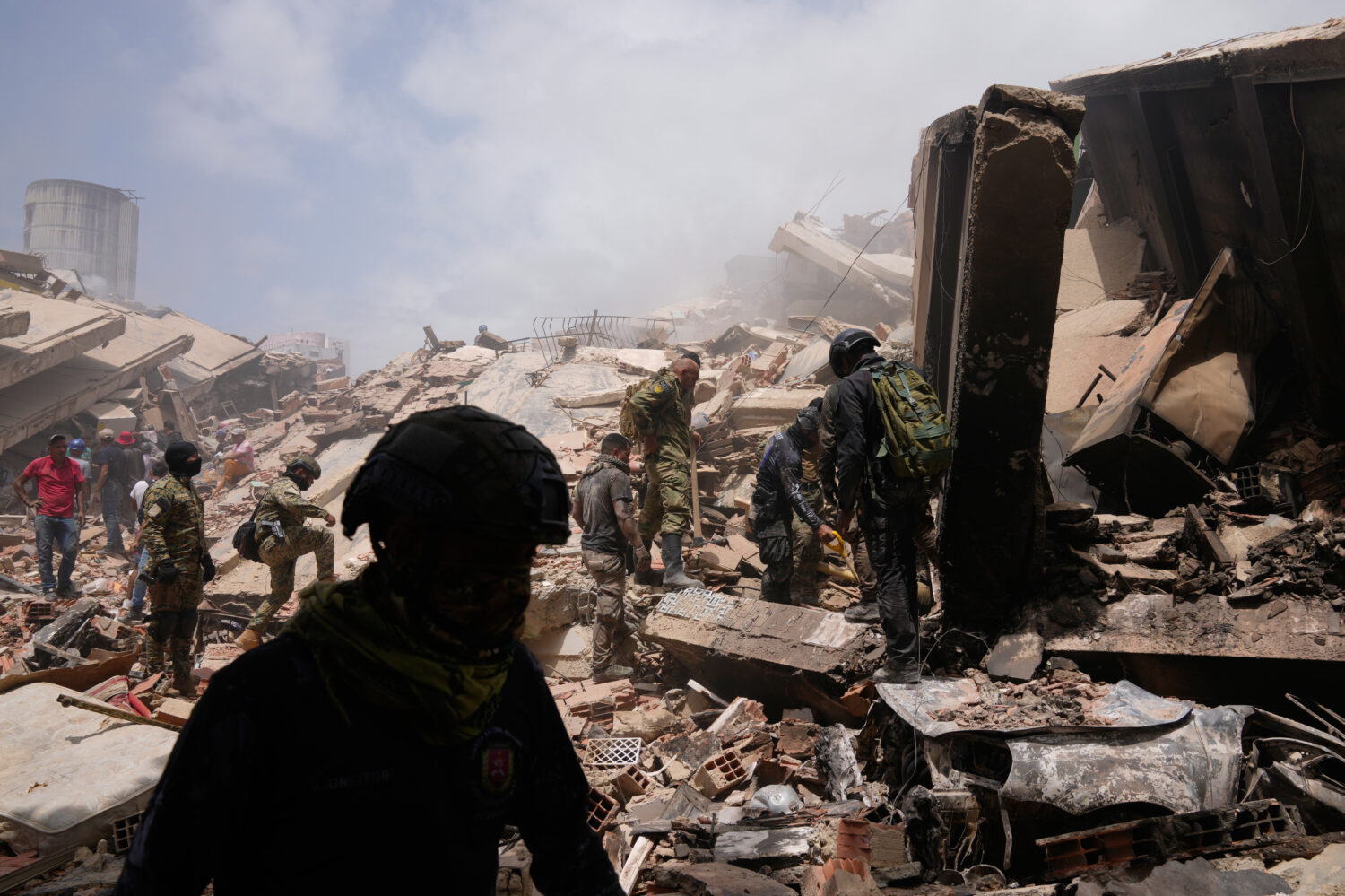 Venezuelan police search for survivors through the rubble in La Guaira, Venezuela, Friday, June 26,...