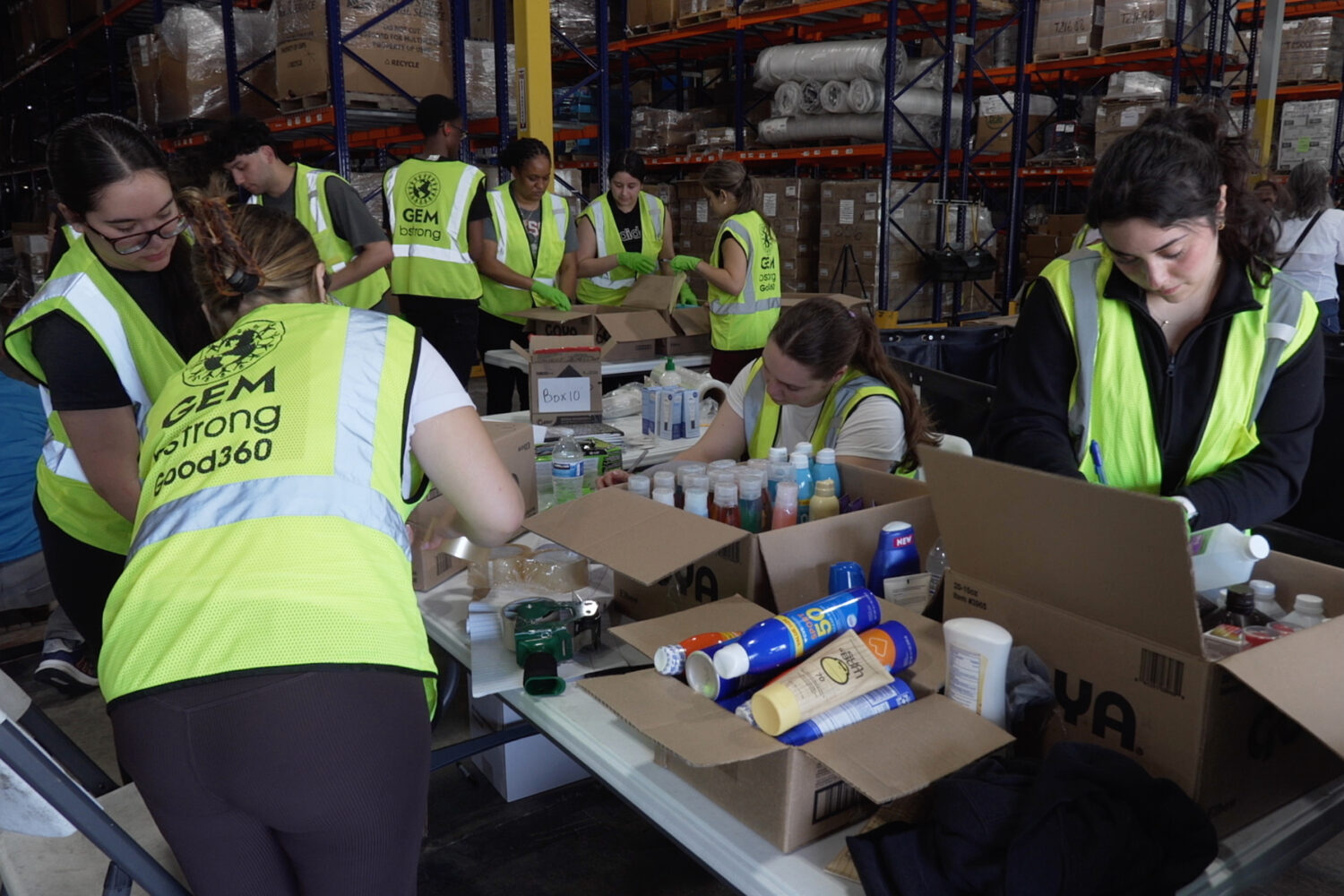 Volunteers are seen packaging supplies, Thursday, June 25, 2026, in Doral, Fla. (AP Photo/Cody Jack...