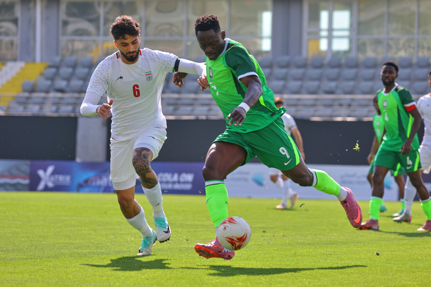 FILE - Nigeria's Akor Adams, right, fights for the ball with Iran's Mohammad Ghorbani during a frie...