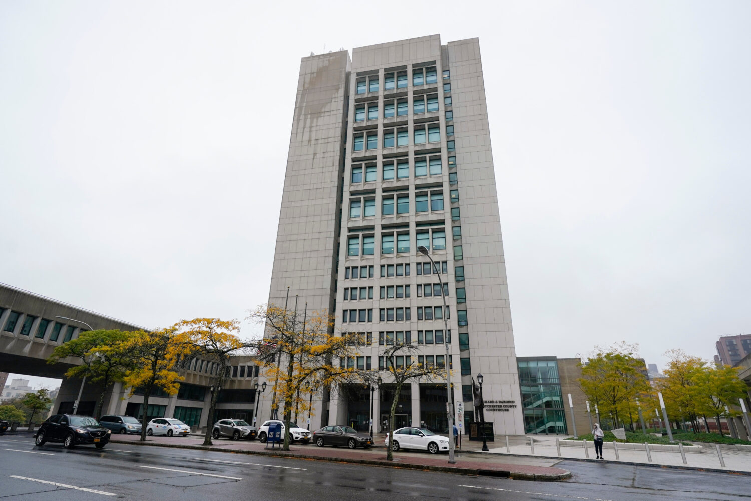 FILE - Pedestrians pass the Richard J. Daronco Westchester County Courthouse, Oct. 13, 2020, in New...