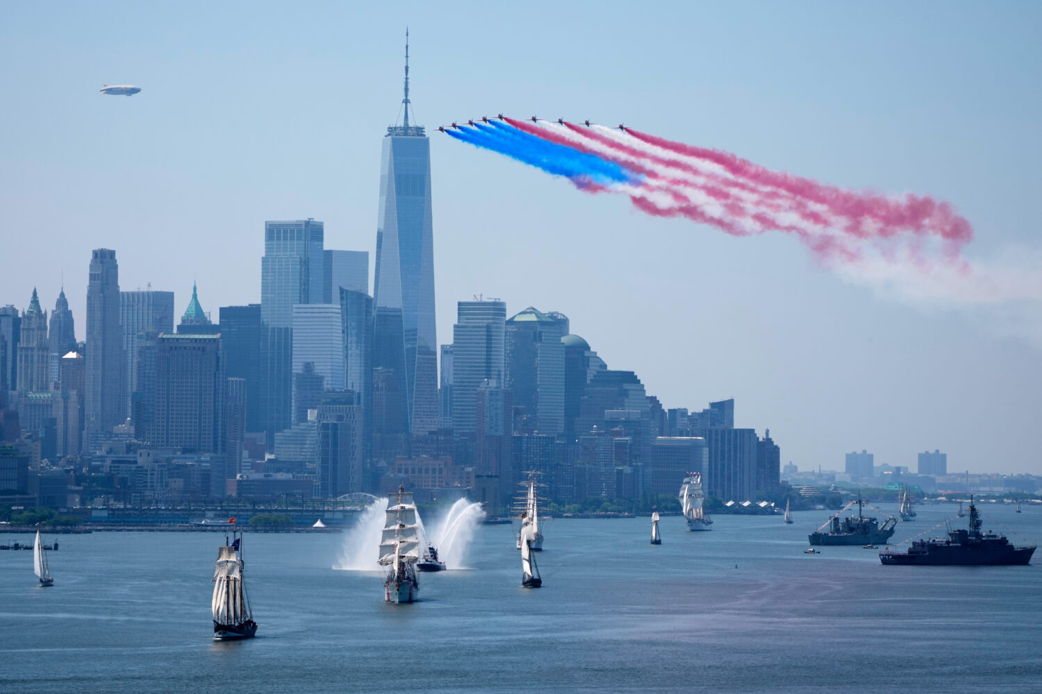 Tall ships parade under flyovers during the International Parade of Sail, part of Sail250, a gather...