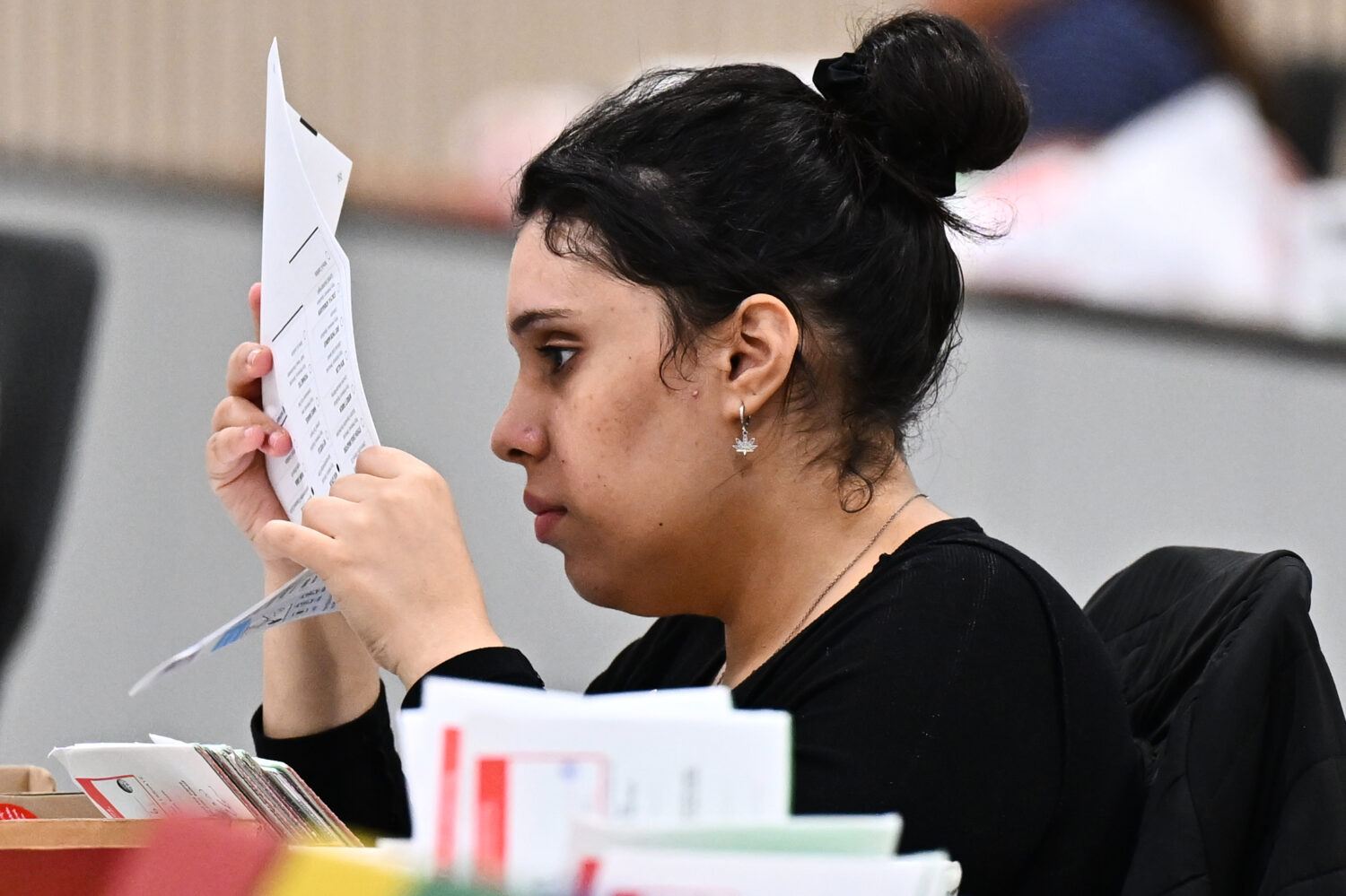 A worker inspects a ballot at the L.A. County Ballot Processing Center during the California primar...