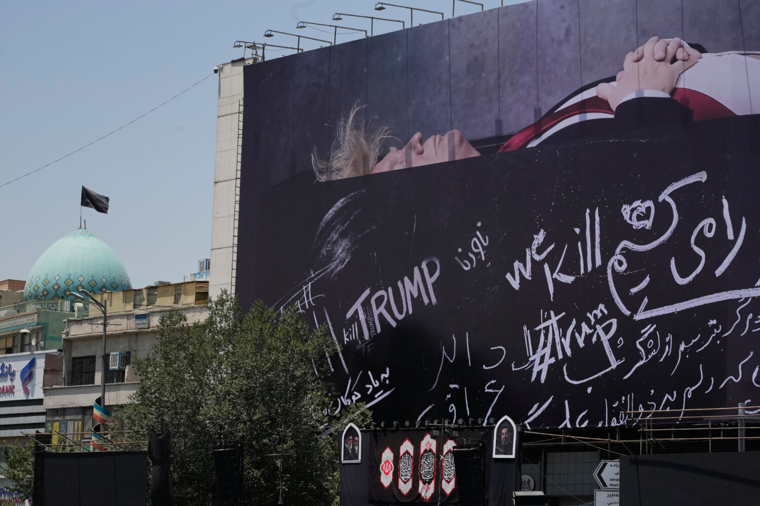 A billboard depicting U.S. President Donald Trump lying on what appears to be a coffin and bearing ...