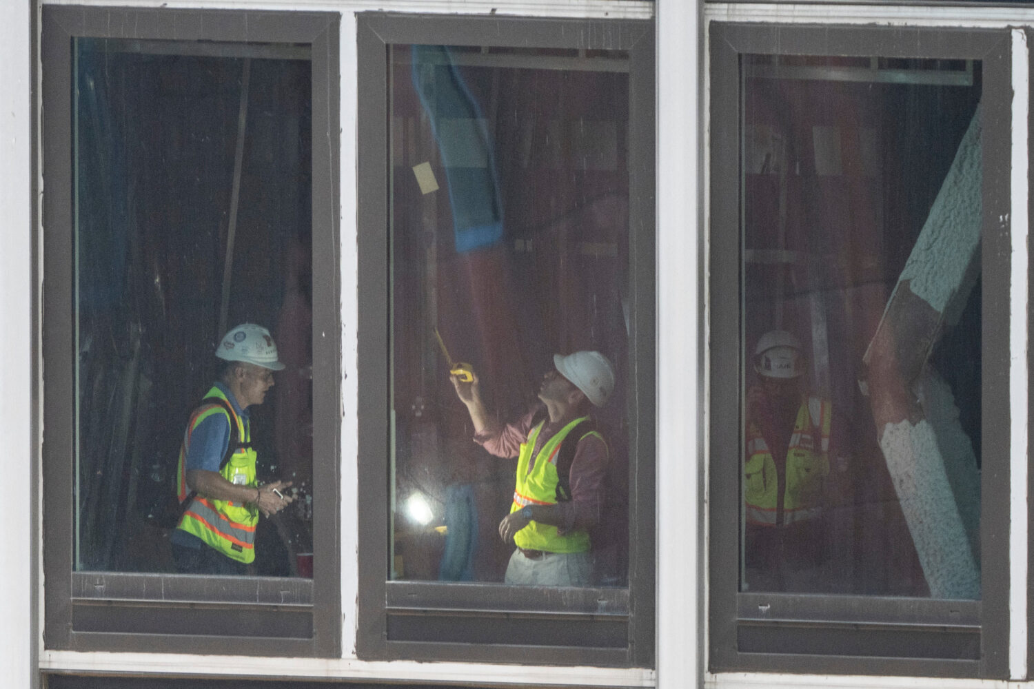 People inspect a buckled support beam inside 235 East 42nd Street, Wednesday, July 8, 2026, in New ...