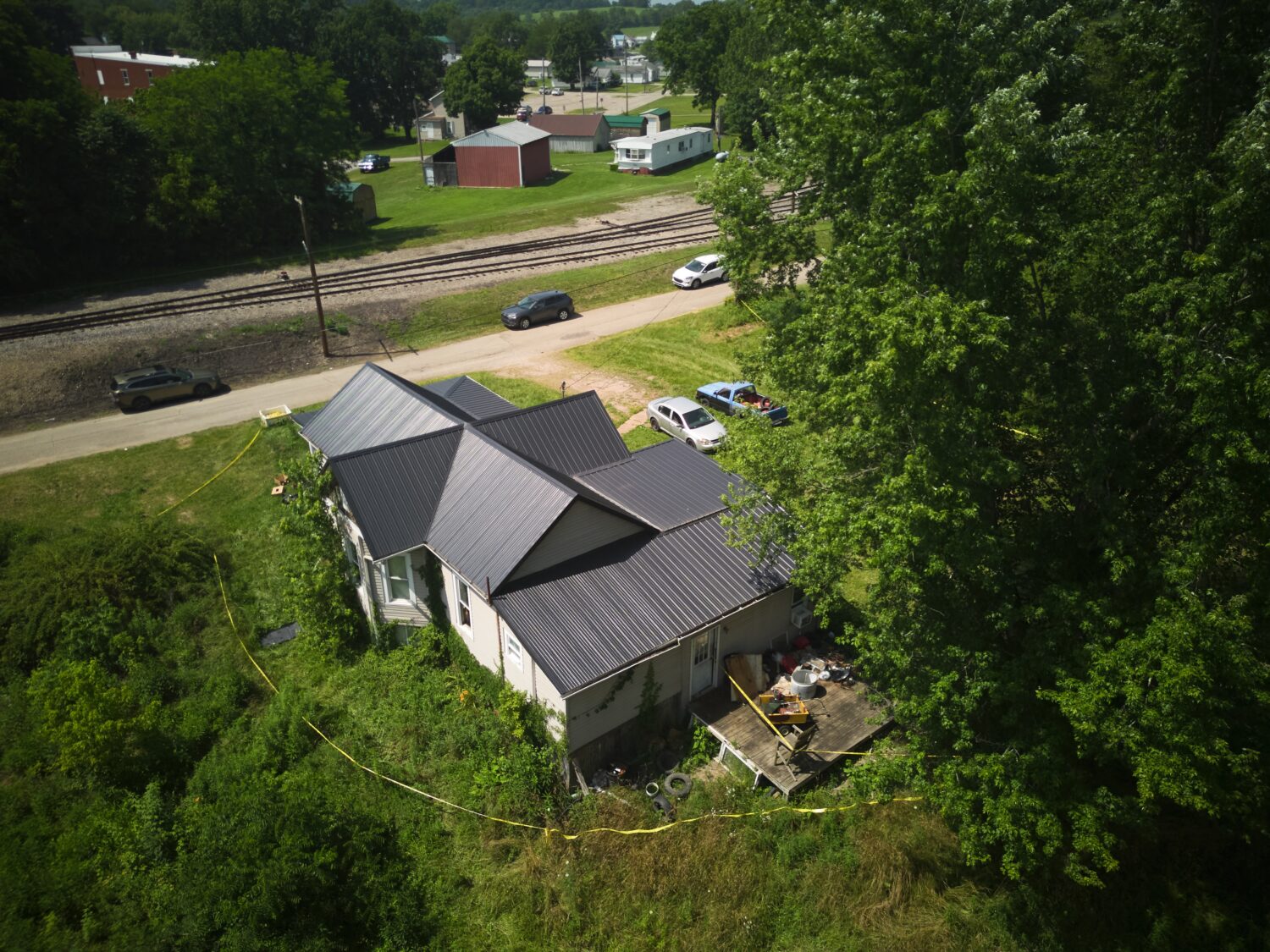 Police tape surrounds a home where authorities say they removed 16 children and arrested four adult...