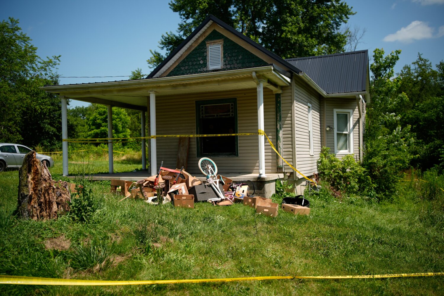 Police tape surrounds a home where authorities say they removed 16 children and arrested four adult...