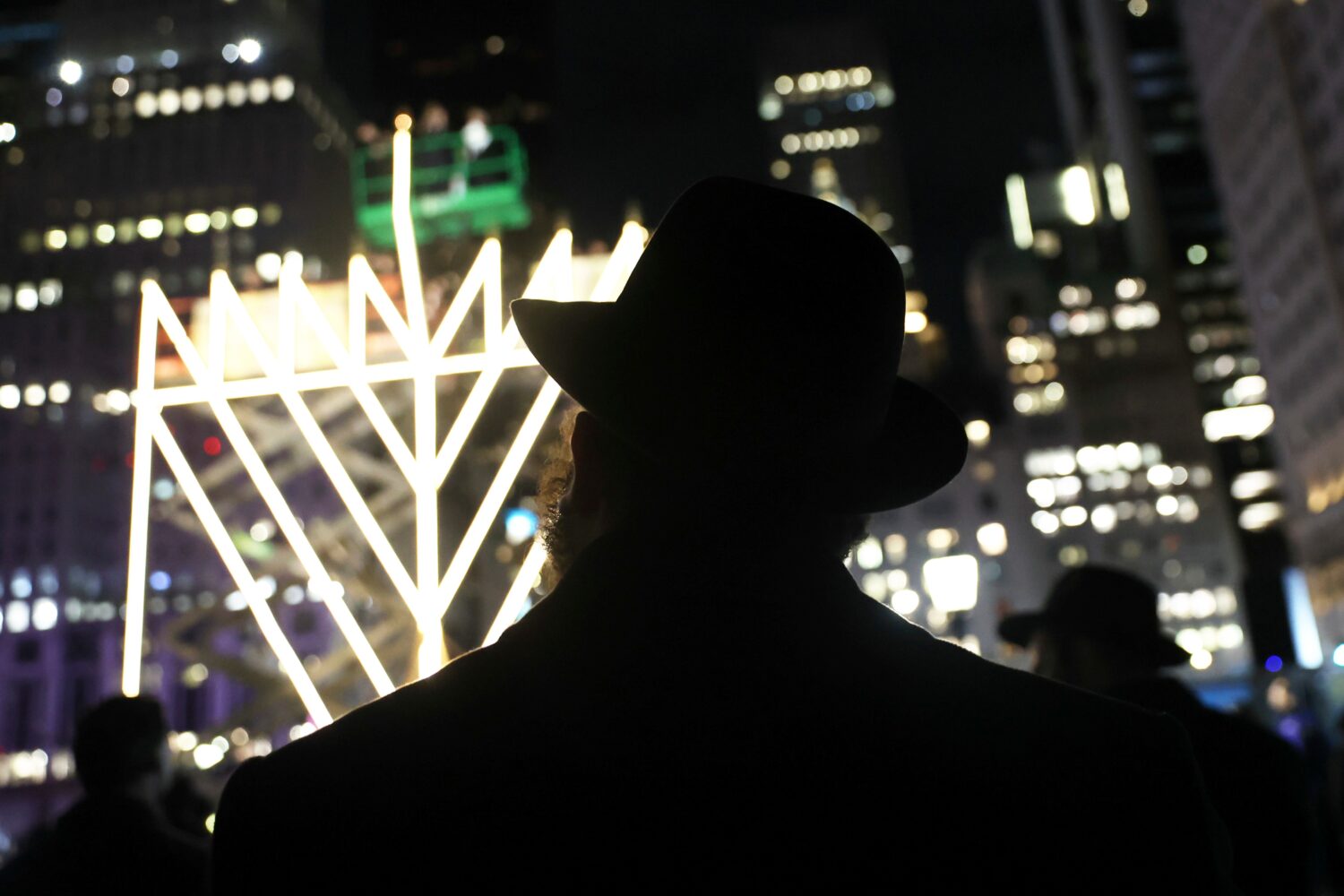 FILE - People watch the lighting of the world's largest menorah on Fifth Avenue by Central Park for...