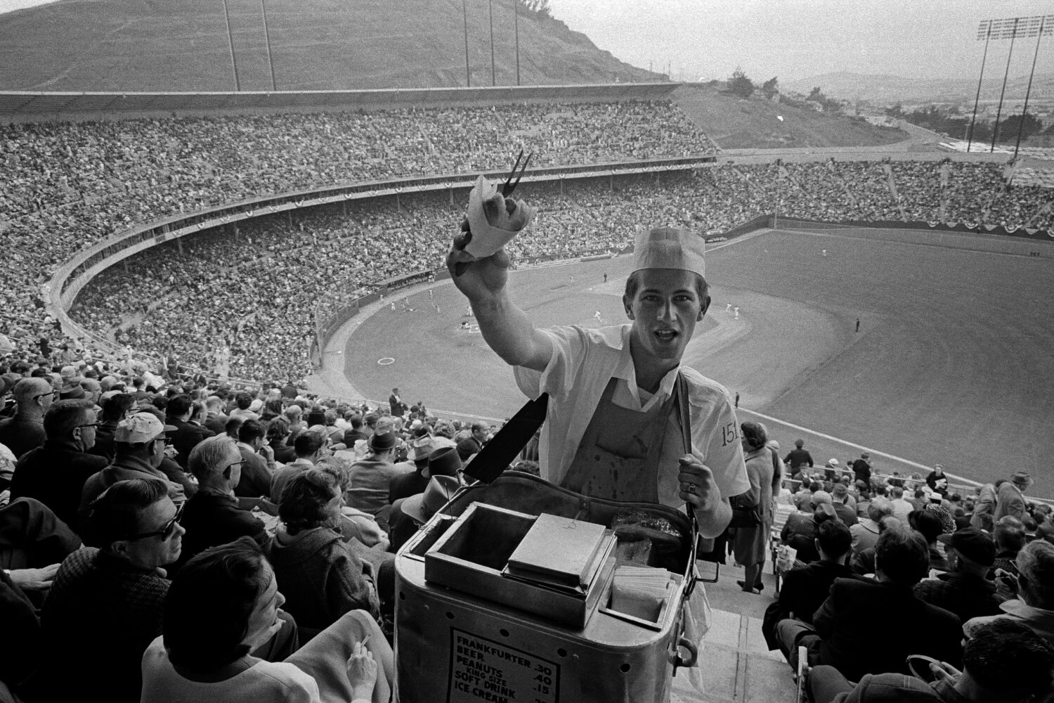 FILE - A hot dog vendor plies his wares amid a large crowd that turned out at Candlestick Park in S...