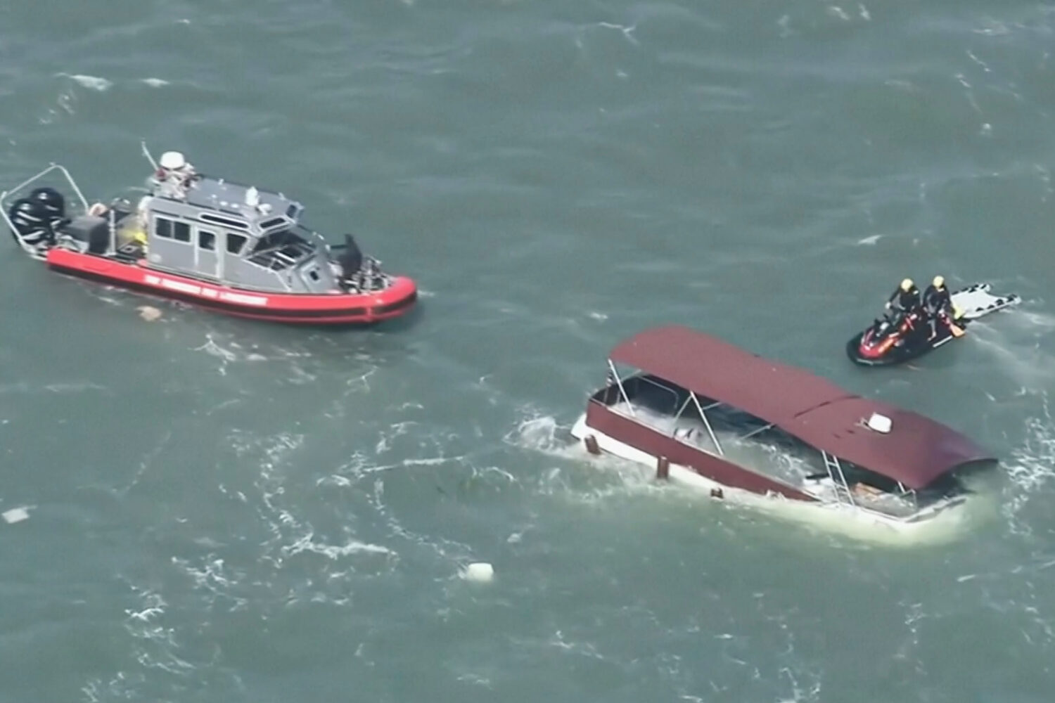 This image made from video provided by KGO-TV shows first responders reacting to a sinking boat Tue...