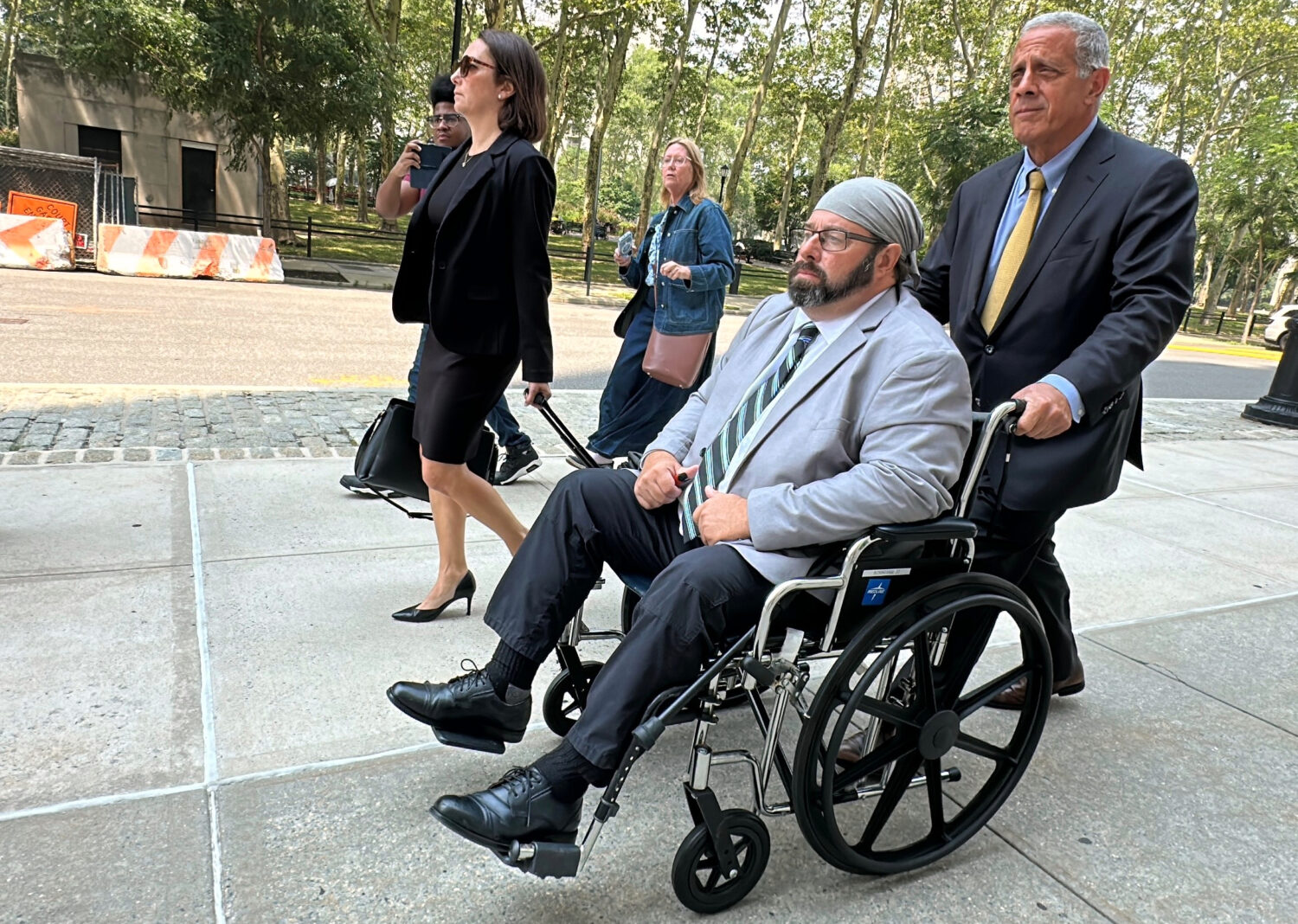 Former cargo ship captain John Merrone is wheeled out of federal court in the Brooklyn borough of N...