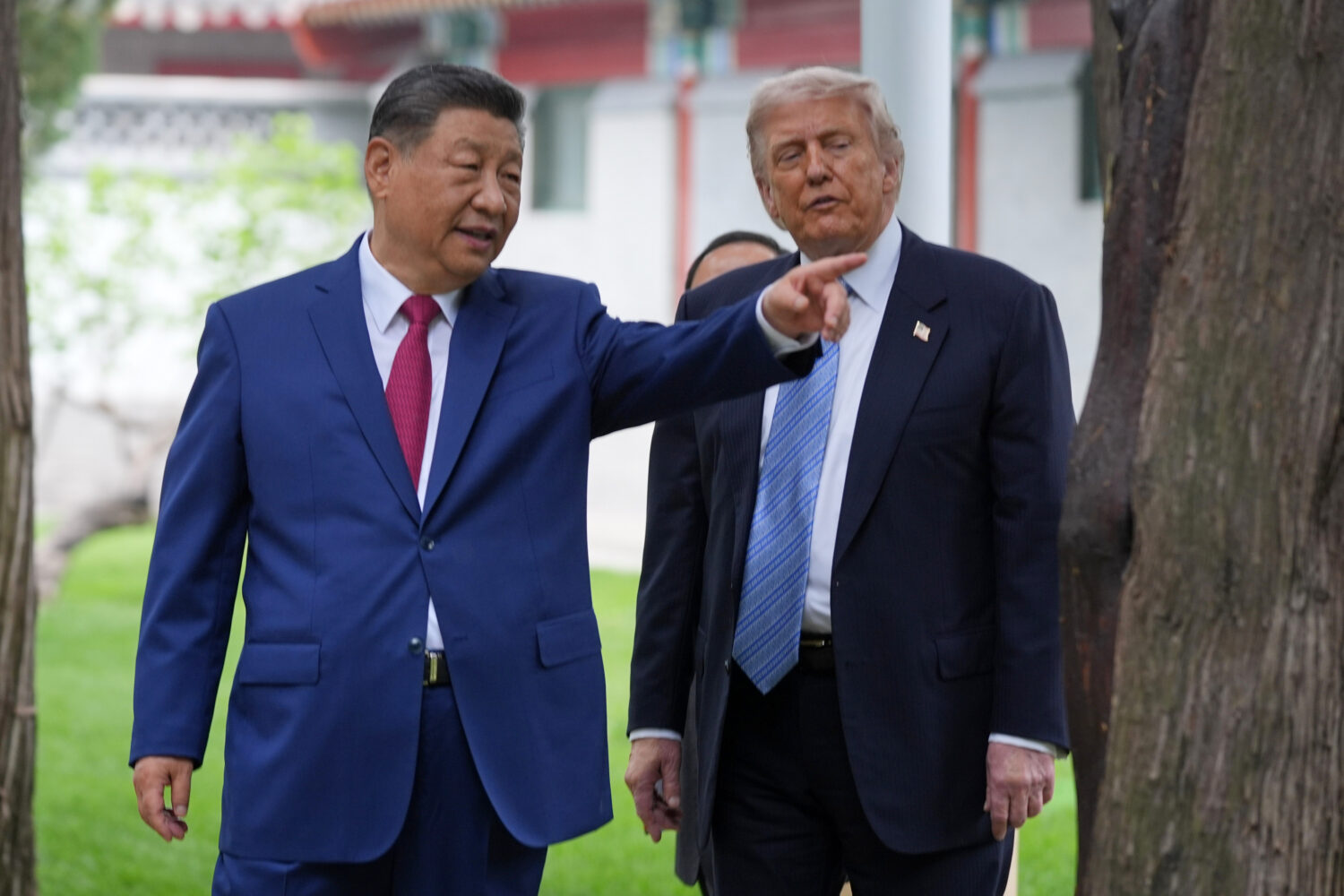 FILE - President Donald Trump talks with China's President Xi Jinping at the Zhongnanhai leadership...
