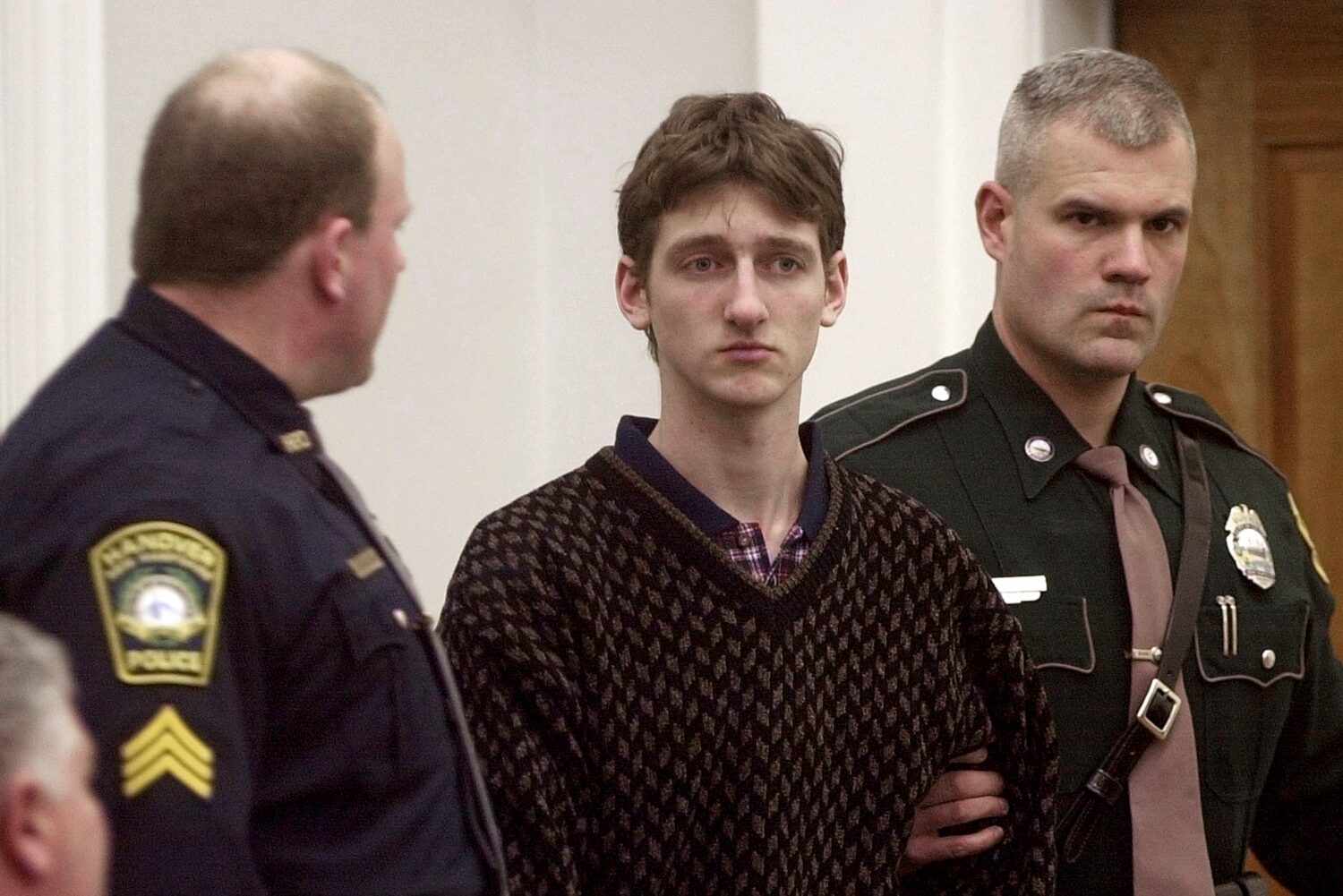 FILE - Robert Tulloch, 17, is escorted into Lebanon, N.H. District Court by Tropper James Stienmetz...