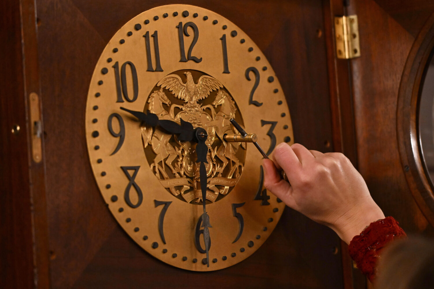 FILE - Bethany Gill winds a clock in the Pennsylvania Supreme Court chamber, Dec. 13, 2024, in Harr...
