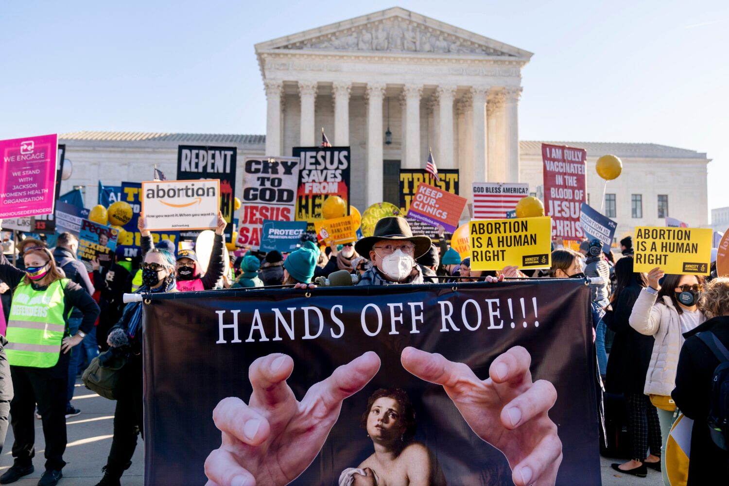 FILE - Stephen Parlato of Boulder, Colo., holds a sign that reads "Hands Off Roe!!!" as abortion ri...