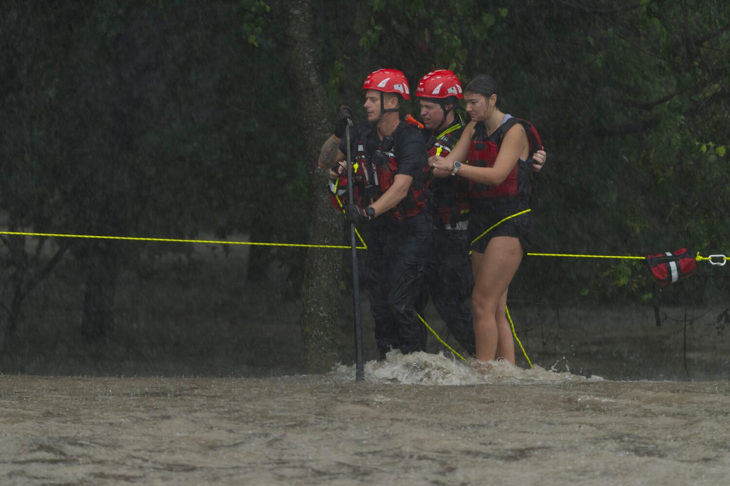 Members of the Boerne Fire Dept. rescue a woman from flood waters on Wednesday, July 15, 2026, in B...