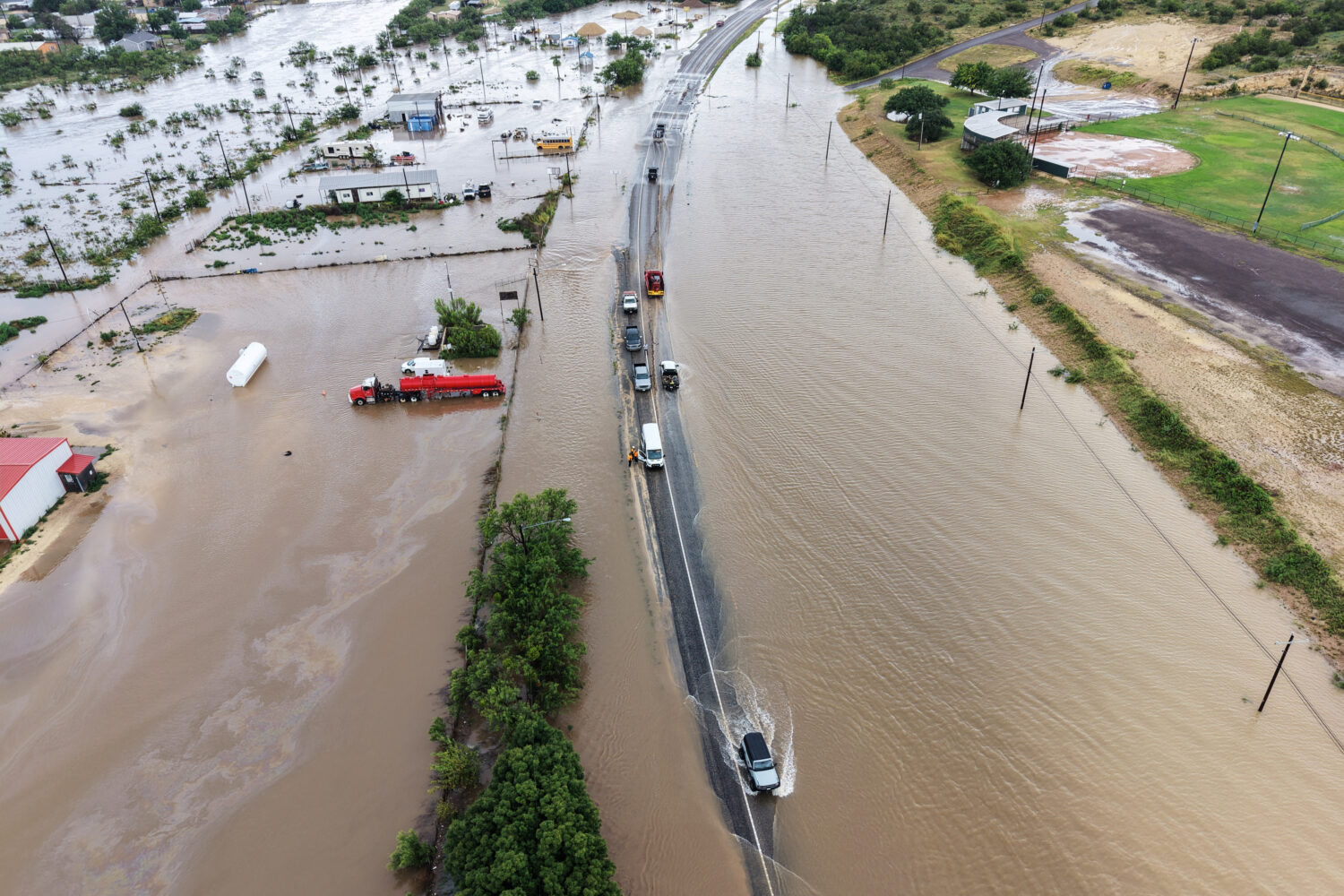 An aerial view shows flooding on Friday, July 17, 2026, in Ozona, Texas. (AP Photo/Gerald Herbert)C...