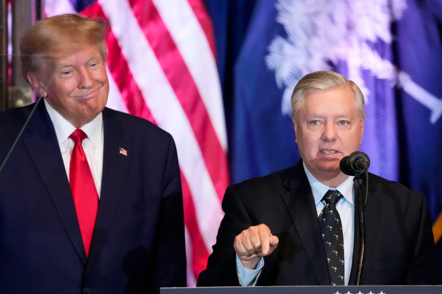 FILE - Former President Donald Trump listens as Sen. Lindsey Graham, R-S.C., speaks at a campaign e...