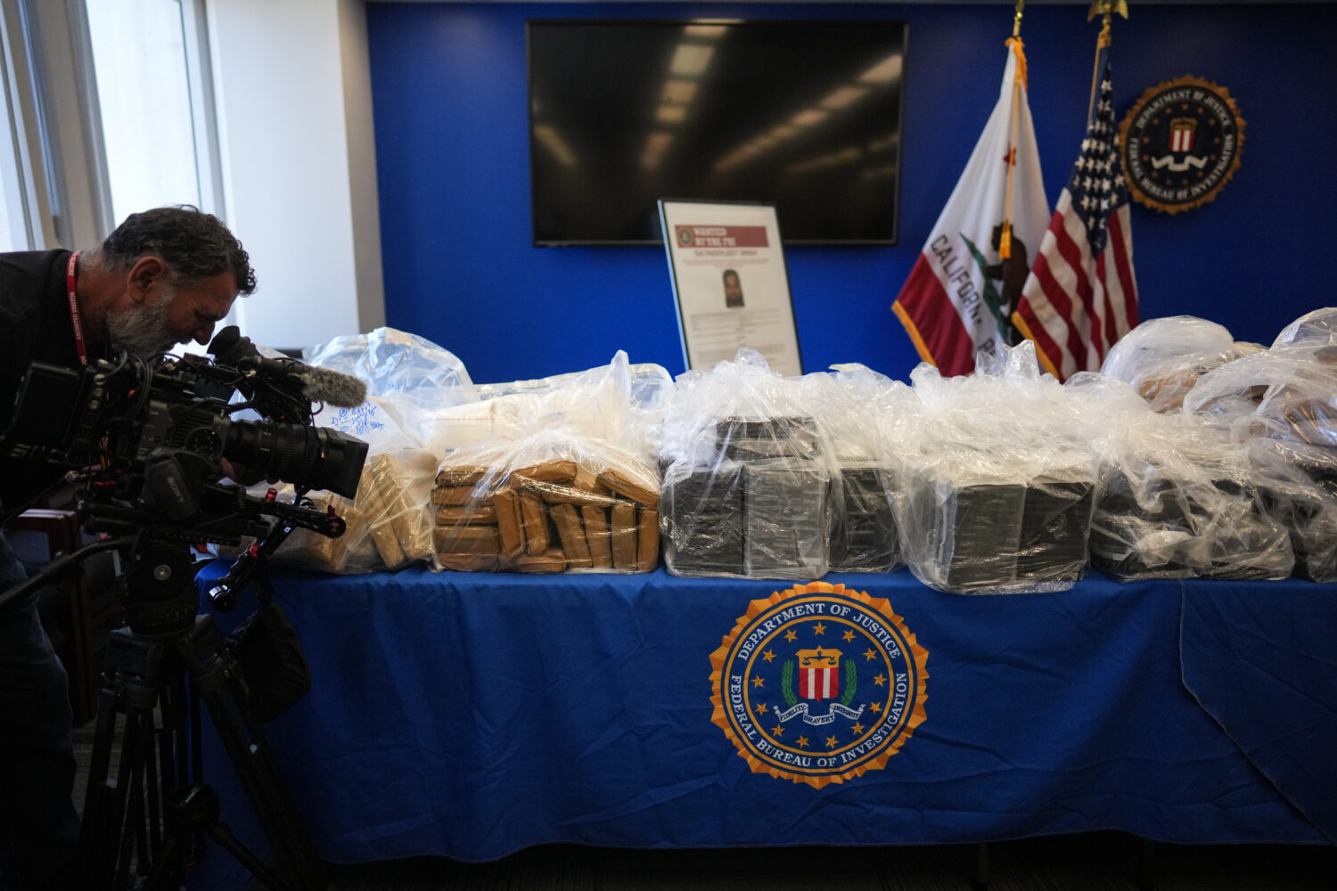A cameraman records seized evidence at a news conference at the Federal Building in Los Angeles, Tu...