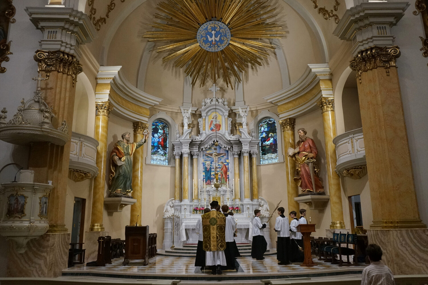 The Rev. John Ubel, pastor of the Church of Saint Agnes, processes into the sanctuary with altar se...