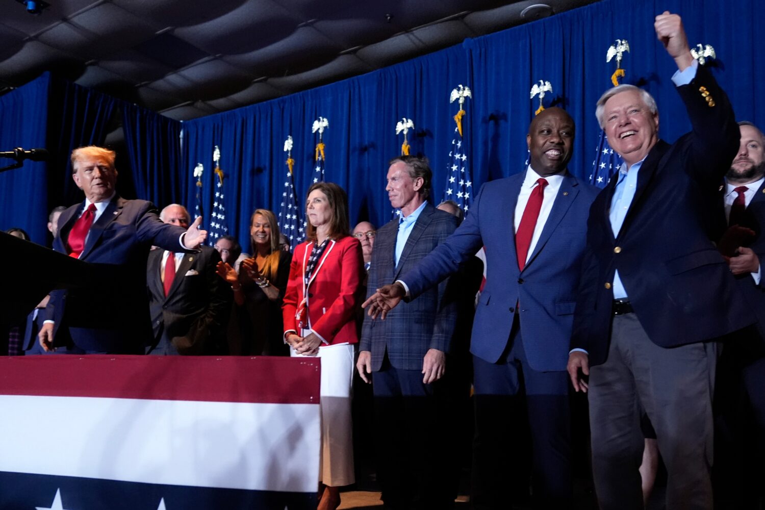 FILE - Republican presidential candidate former President Donald Trump speaks as Sen. Tim Scott, R-...