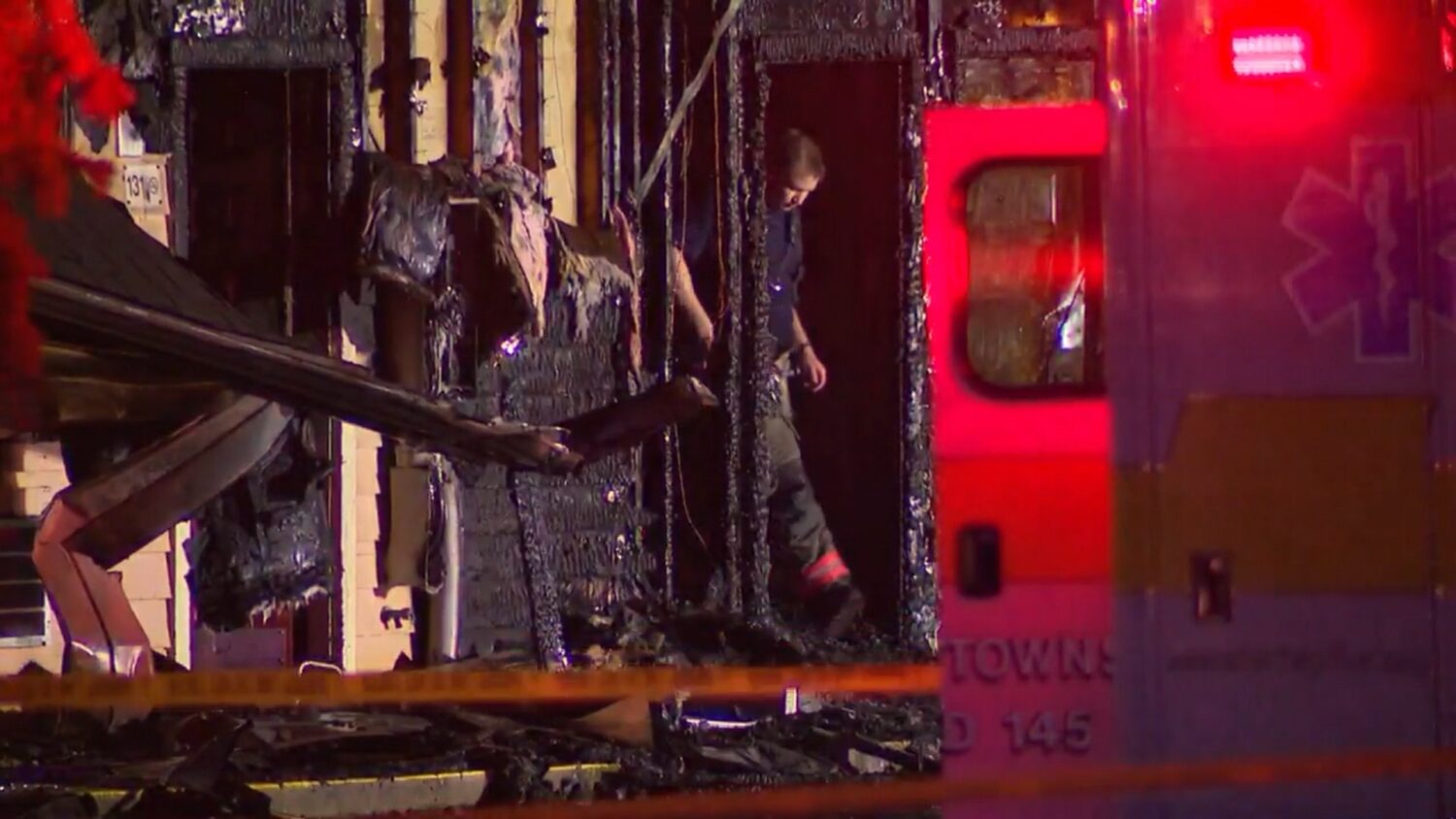 In this photo, taken from video, a firefighter exits the charred remains of an Econo Lodge motel in...