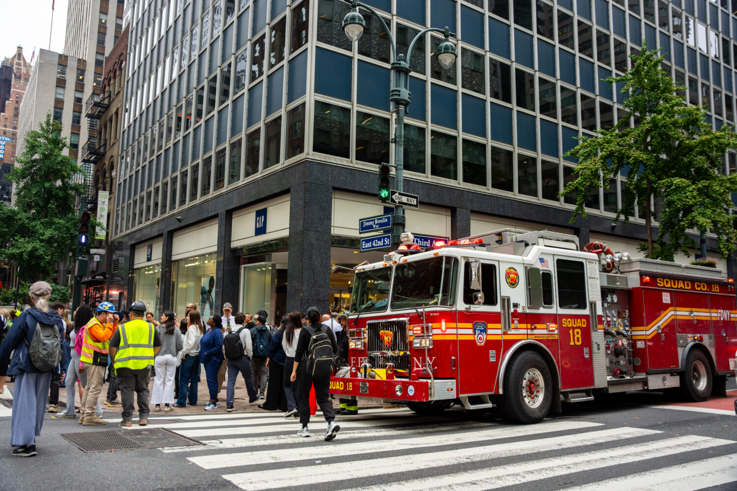 A firetruck is parked at the intersection of 3rd Avenue and East 42nd Street after buildings in the...