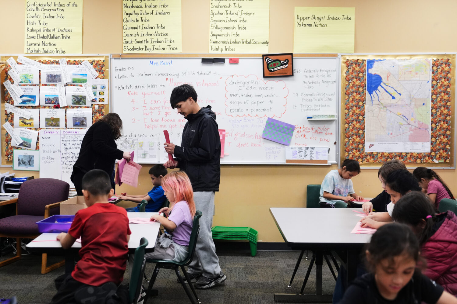 Chief Leschi Schools senior Gerald Dillon, 18, helps during a weaving exercise in a culture class f...