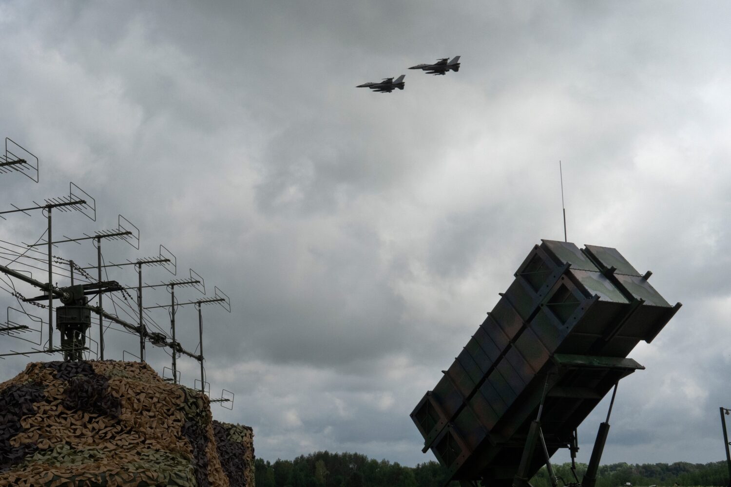 FILE - Ukrainian Air Force's F-16 fighter jets fly over a Patriot Air and Missile Defense System in...