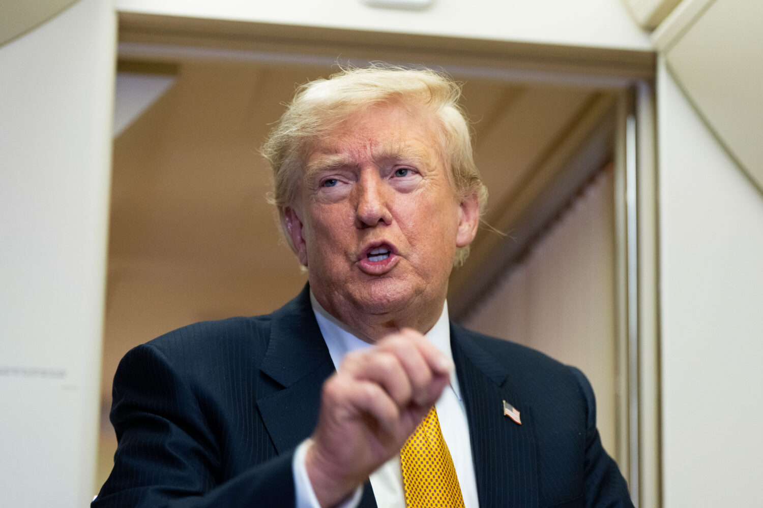 President Donald Trump speaks with reporters in flight on Air Force One after landing at U.S. Air F...