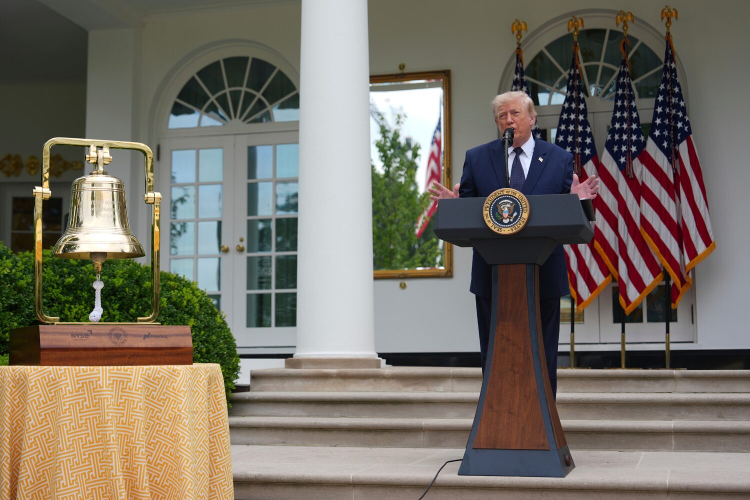 President Donald Trump speaks alongside the New York Stock Exchange bell at a lunch in the White Ho...