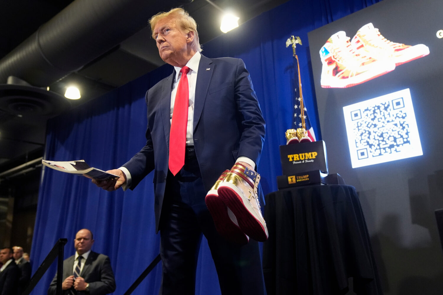 FILE - Donald Trump holds a Playboy magazine and gold Trump sneakers at Sneaker Con Philadelphia, a...