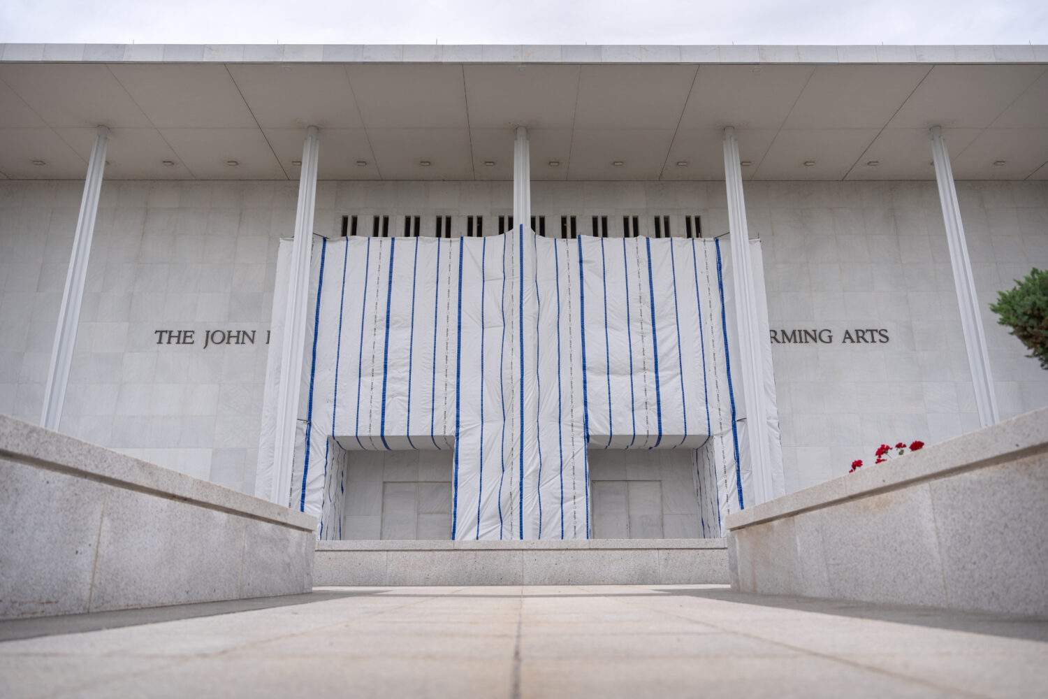 The John F. Kennedy Center for the Performing Arts is seen, as its sign remains covered by a tarp, ...