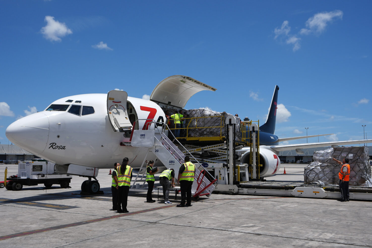 People load pallets containing food and hygiene kits for a humanitarian assistance flight to Cuba o...